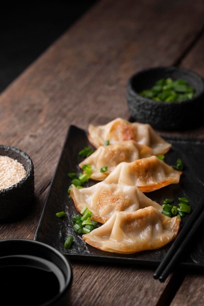 Free photo high angle of asian dish on plate with herbs