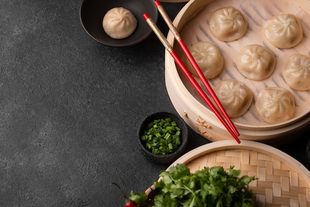 Free Photo high angle of asian dumplings with chopsticks and copy space