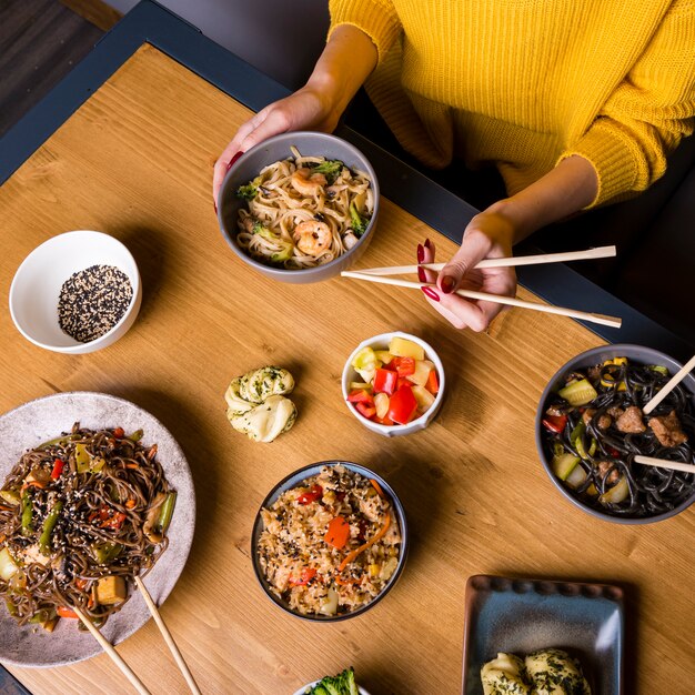 High angle of assortment of asian food on table