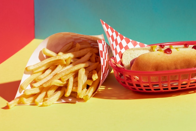 Free photo high angle assortment with fries and hot dog in basket