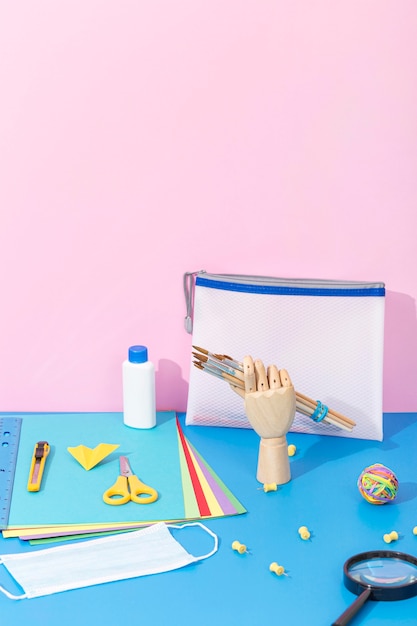 Free Photo high angle of back to school supplies with scissors and magnifying glass