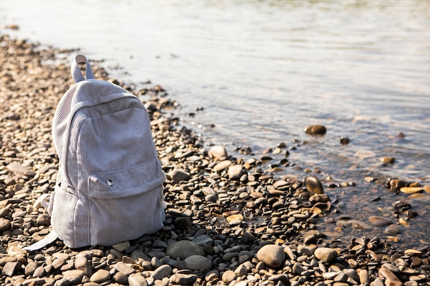 Free Photo high angle backpack beside seaside