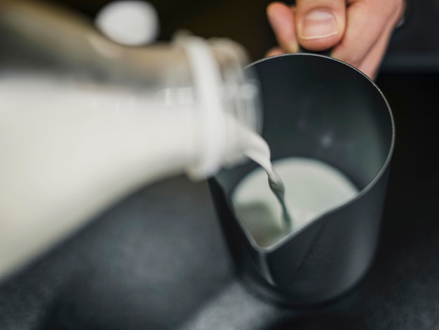 Free Photo high angle of barista pouring milk