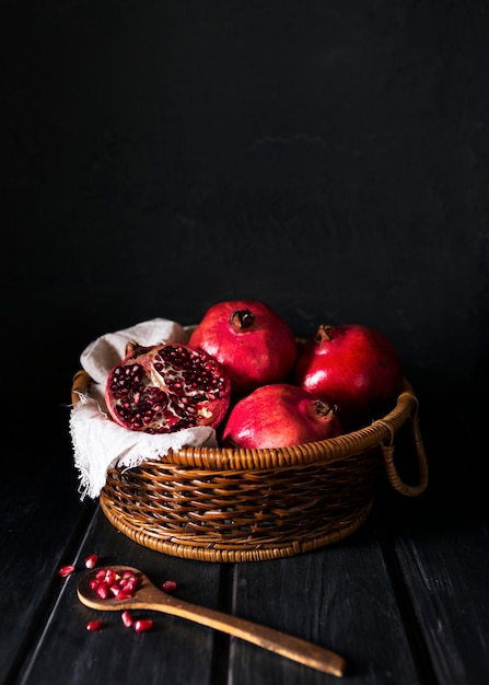 High angle of basket with autumn pomegranates and copy space