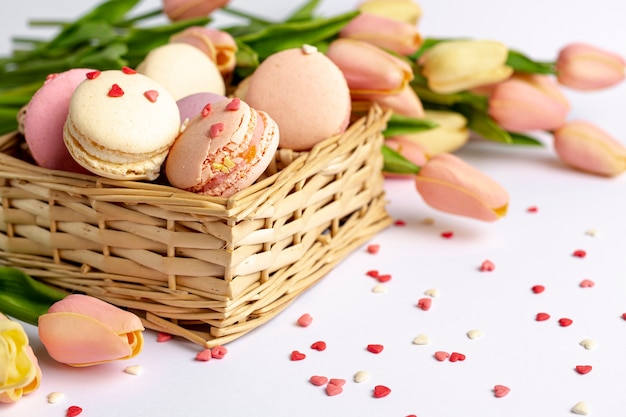 High angle of basket with macarons and tulips for valentines day