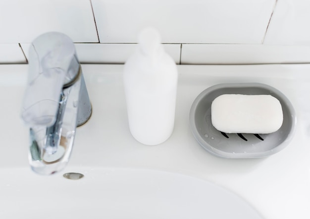 High angle of bathroom sink with soap