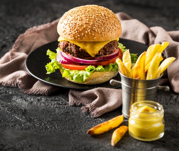 Free photo high angle beef burger, fries and sauce with beer