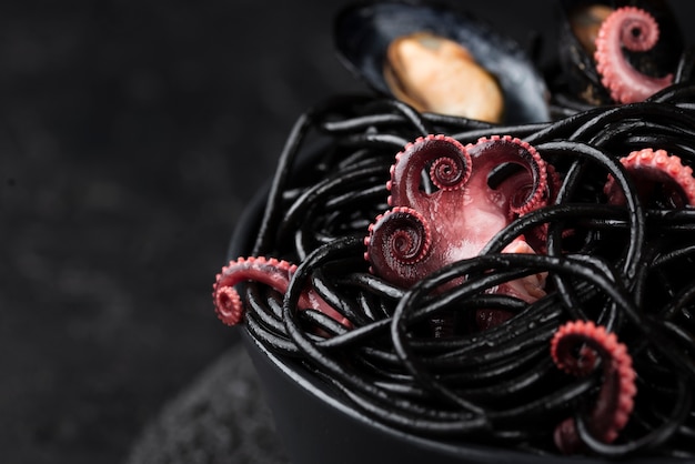 High angle of black pasta with squid