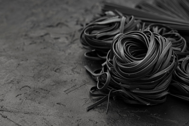 Free Photo high angle of black tagliatelle on slate