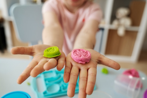 High angle blurry kid with playdough