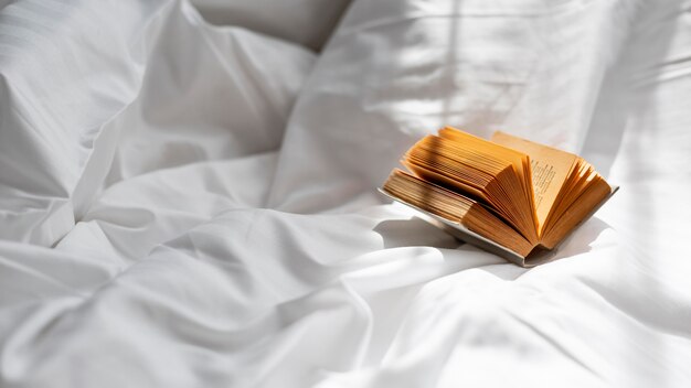 High angle book on bedsheet