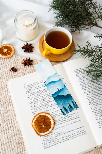 Free photo high angle bookmark and tea cup assortment