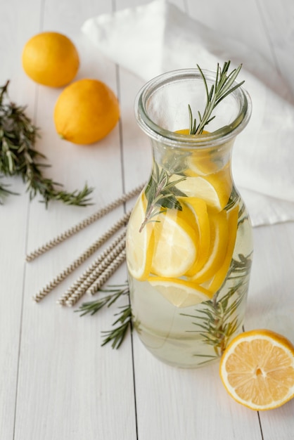 Free photo high angle bottle with lemon slices