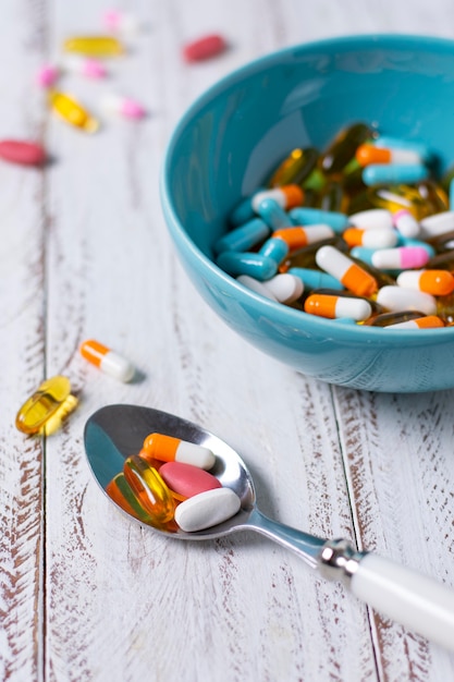 Free Photo high angle bowl and spoon with pills