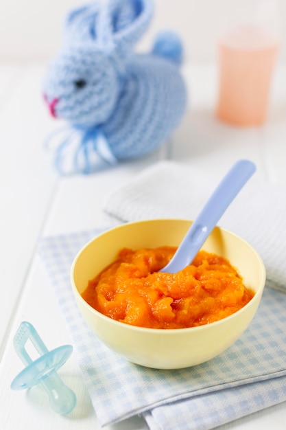 High angle bowl with baby food and spoon