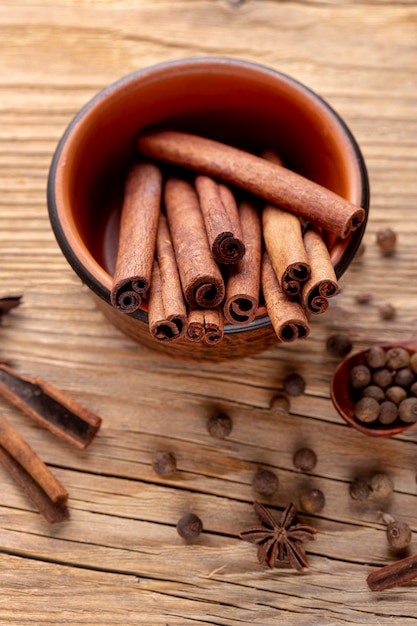 Free photo high angle of bowl with cinnamon sticks and star anise