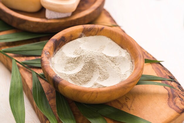 High angle of bowl with powder and leaves