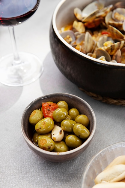 Free Photo high angle bowls with shells and olives