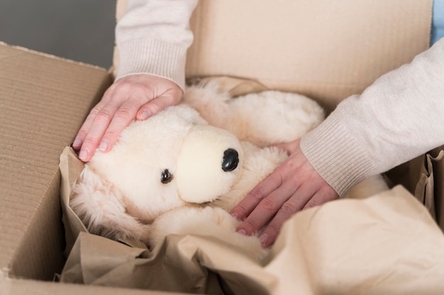 Free photo high angle of box with teddy bear being prepared to be shipped