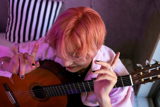 High angle boy holding guitar