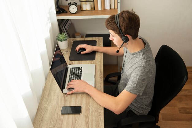 High angle boy playing an online game with his friends