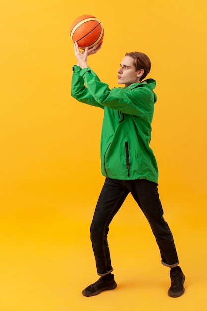 High angle boy playing with basketball ball