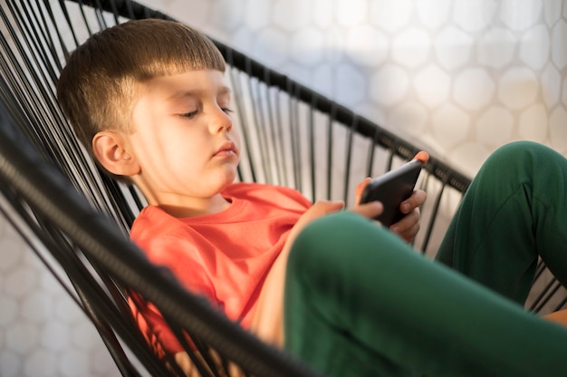 Free photo high angle boy with tablet playing