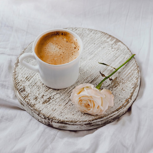 High angle of breakfast coffee with rose