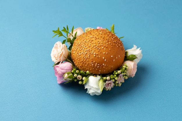 Free Photo high angle burger with flowers on blue background