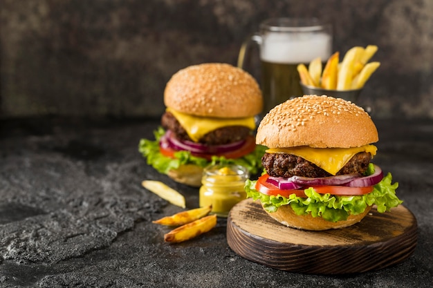 High angle burgers with fries, sauce and beer with copy-space