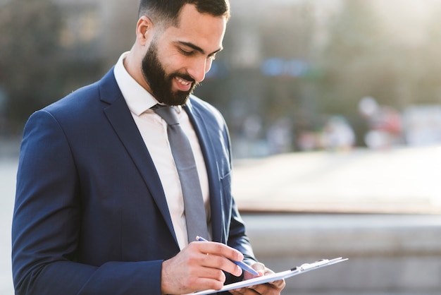 High angle business man checking clipboard