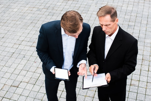 Free photo high angle businessmen discussing information