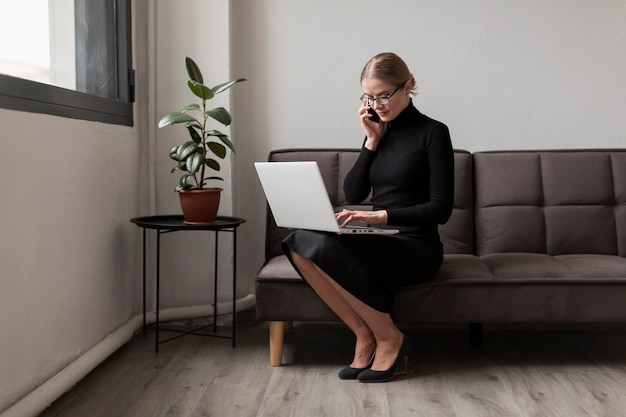 High angle busy woman talking over phone