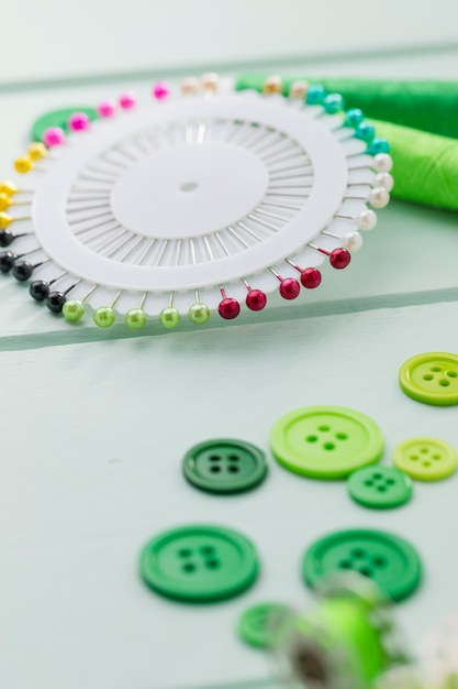 Free Photo high angle of buttons with sewing needles