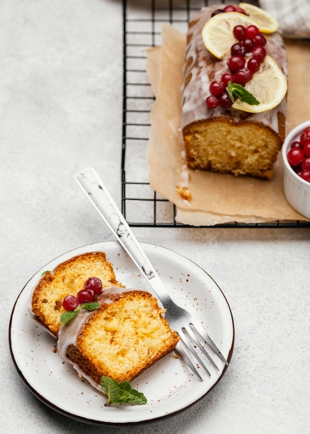 Free photo high angle of cake slices on plate with berries and fork