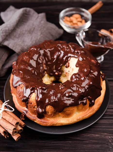 High angle of cake with chocolate topping and cinnamon sticks