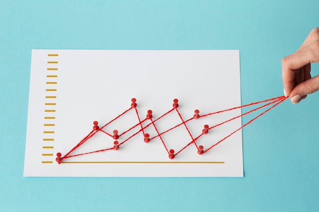 Free photo high angle of chart statistics presentation with hand