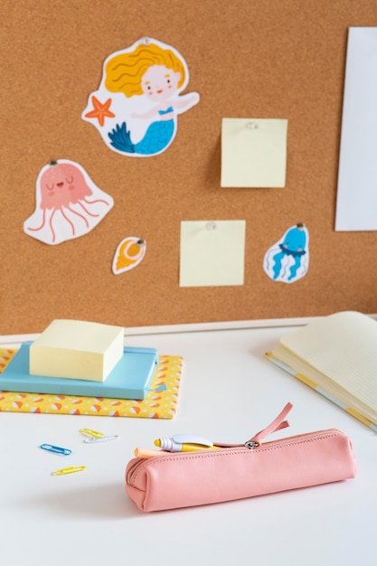 Free photo high angle of children's desk with sticky notes and board