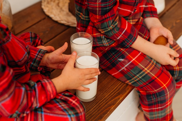 Free photo high angle children wanting to drink milk