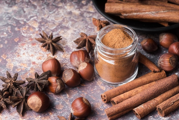 Free photo high angle cinnamon sticks and hazelnuts