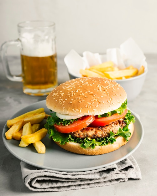 High angle close-up burger with fries on plate