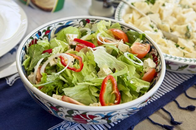 High angle closeup shot of a green salad with vegetables