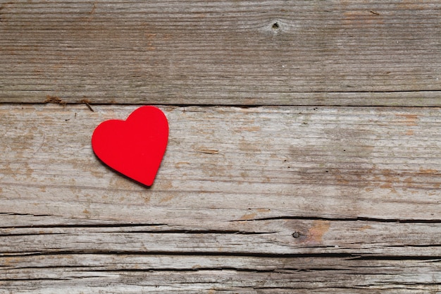 High angle closeup shot of red heart on a wooden surface