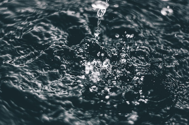 High angle closeup shot of the splashes of water on the surface of a lake