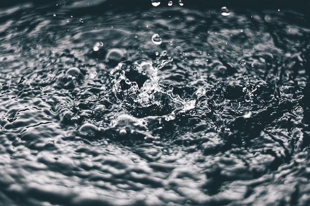 High angle closeup shot of the splashes of water on the surface of a lake