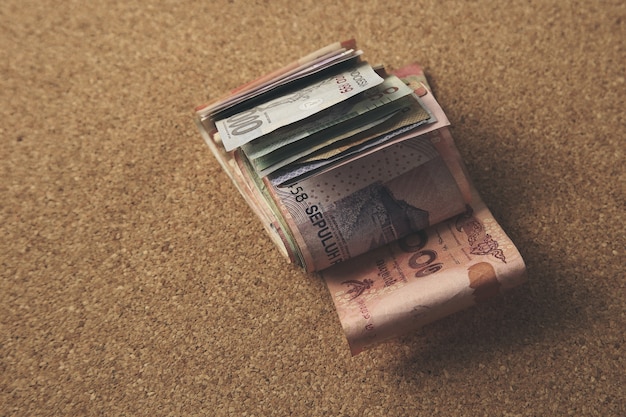 Free photo high angle closeup view of cash money on a brown background