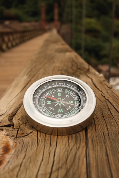 Free photo high angle compass on bridge edge