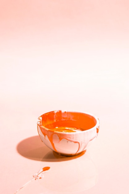 Free photo high angle composition with orange paint in bowl