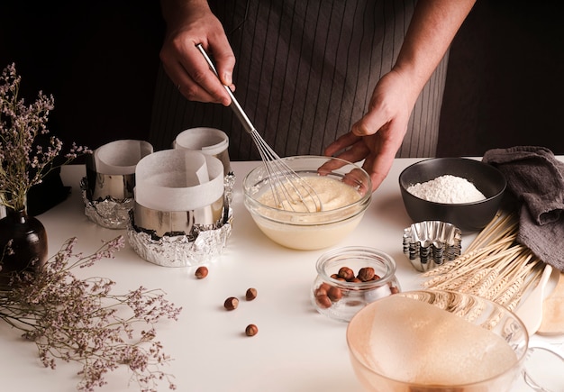 High angle of cook whisking mixture in bowl