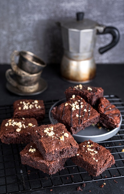 Free photo high angle of cooling rack with brownies and kettle